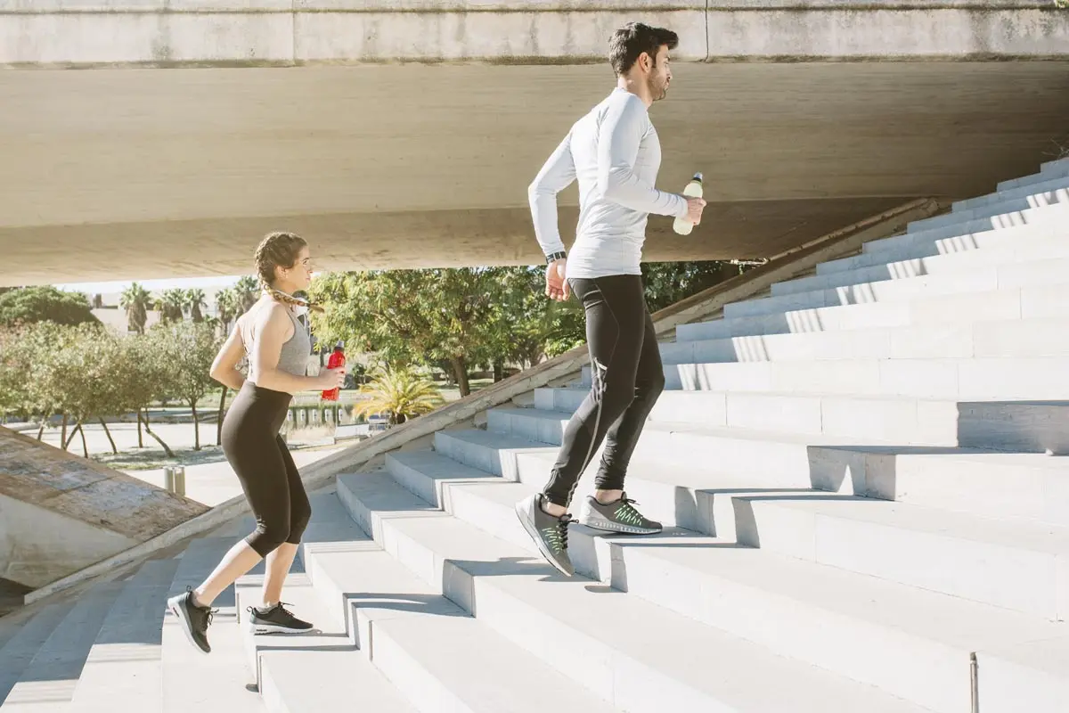 Two people exercising on stairs, symbolizing the connection between health and success.
