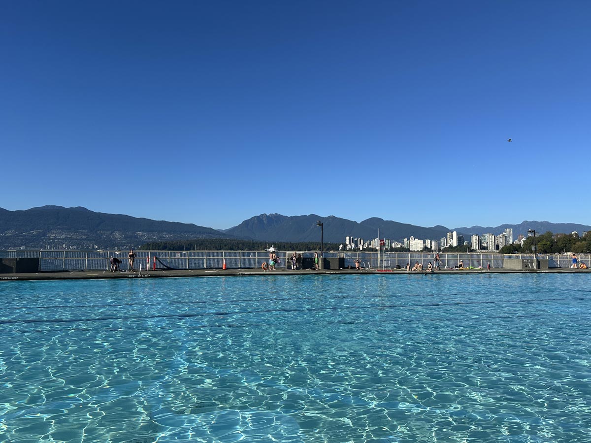 Kitsilano Beach outdoor saltwater pool with city and mountain views.