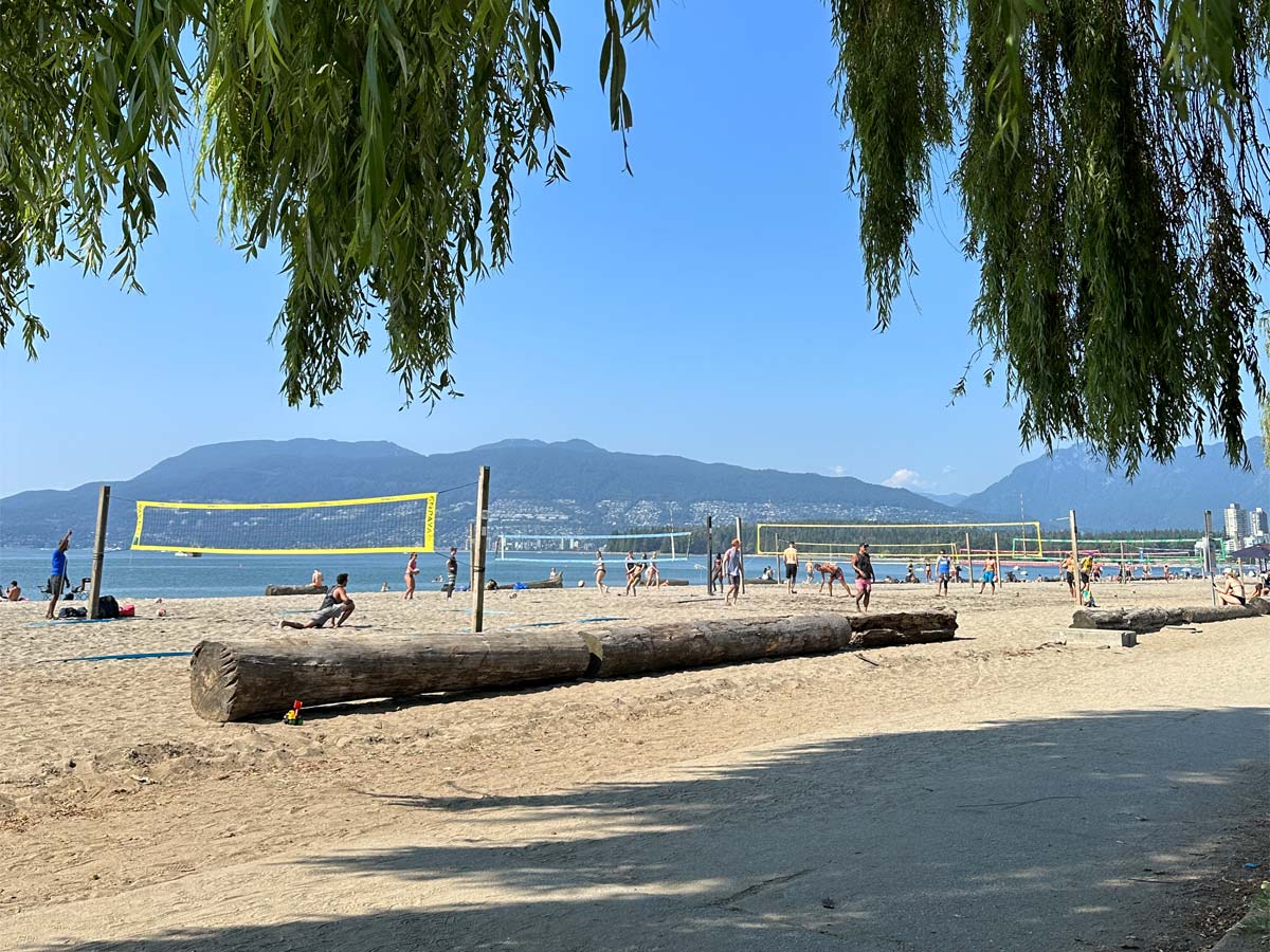 Beach volleyball courts and log seating at Kitsilano Beach.