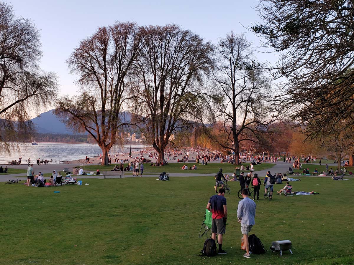 Crowds enjoying the sunset at Kitsilano Beach park in Vancouver.