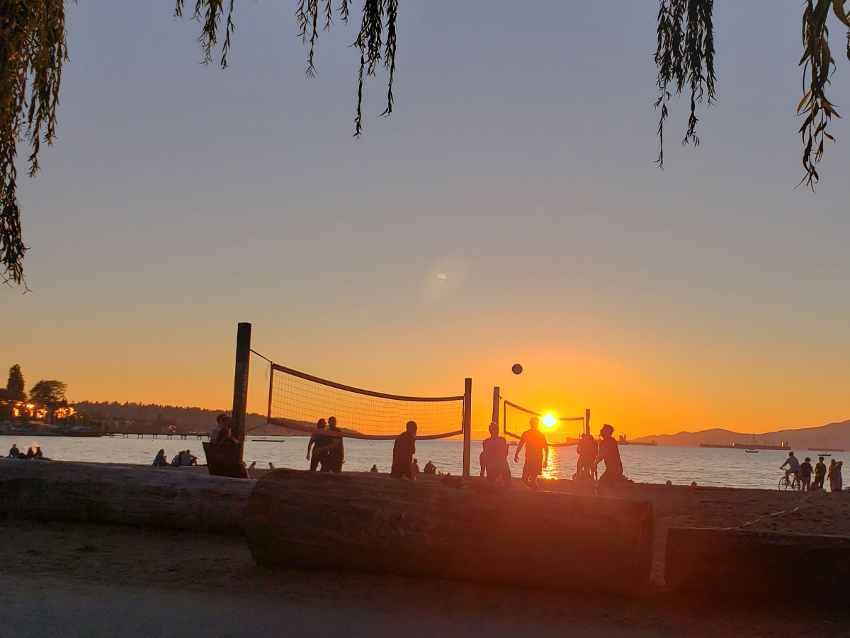 Beach volleyball at sunset on Kitsilano Beach in Vancouver.