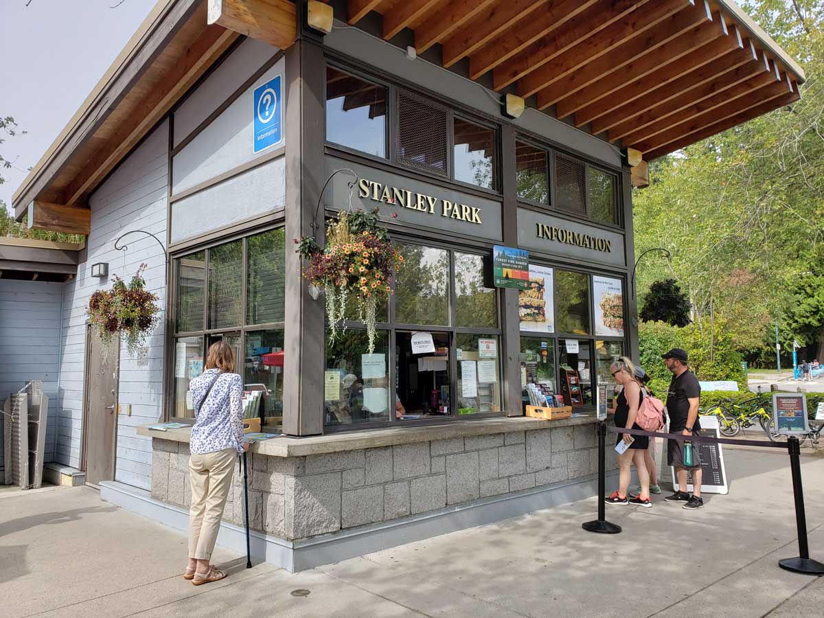 Stanley Park Information Office with visitors seeking details.