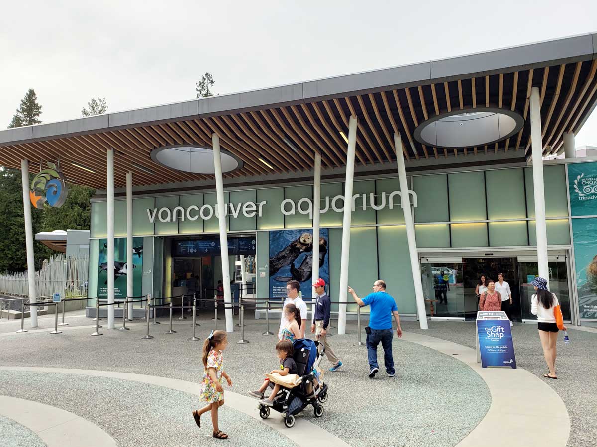 Entrance of the Vancouver Aquarium in Stanley Park with visitors.