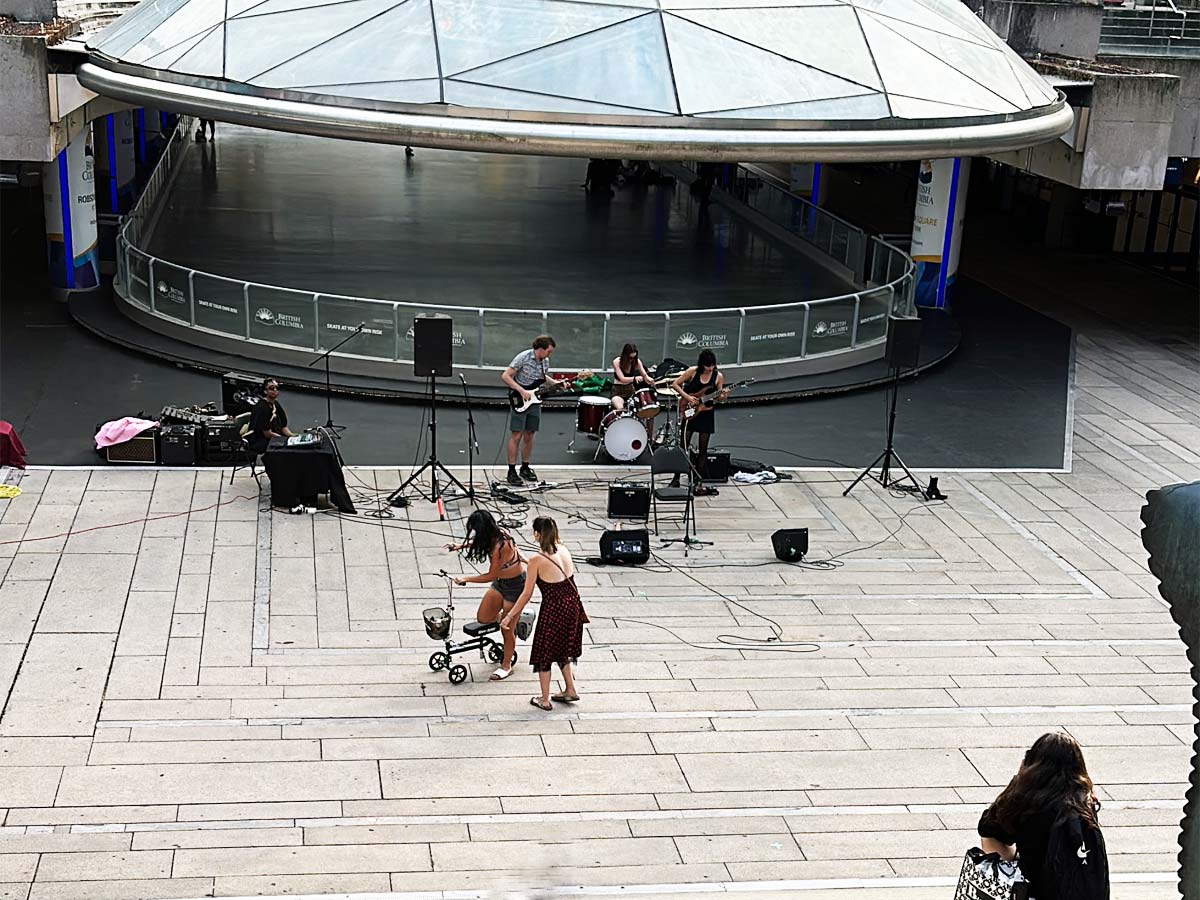 Live band performance with dancers at Robson Square’s lower plaza.