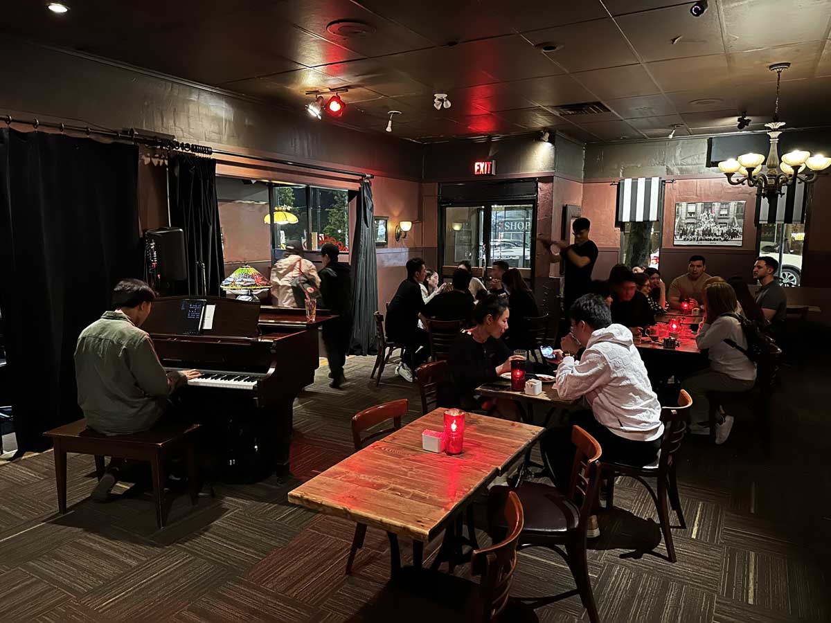 Cheesecake etc interior with a person playing piano.