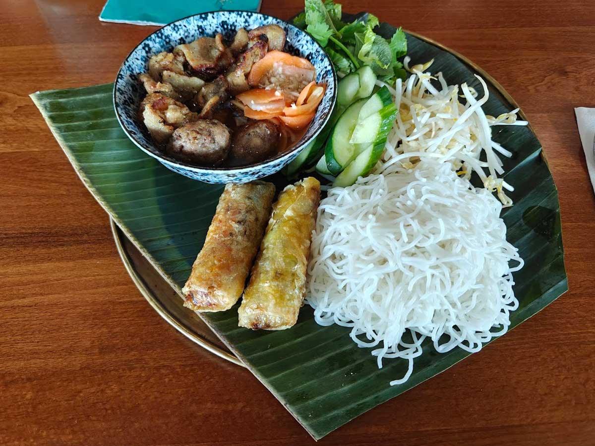 Bun Cha with grilled pork, spring rolls, and vermicelli.