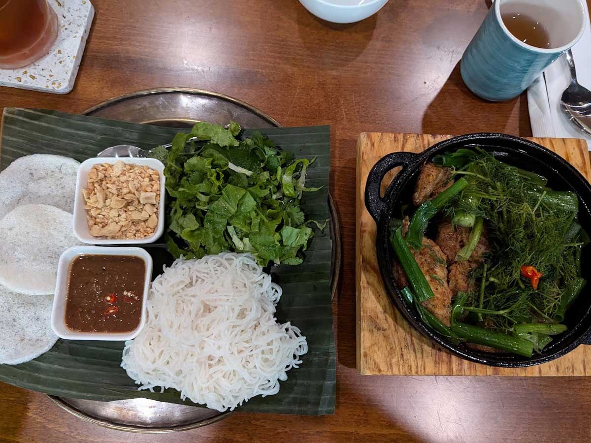 Cha Ca La Vong with dill, herbs, vermicelli, and dipping sauce.