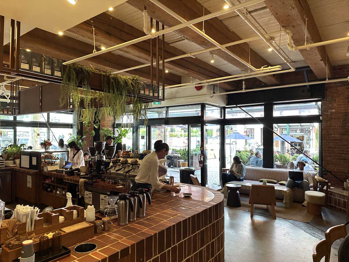 Baristas working inside Analog Coffee Yaletown café.