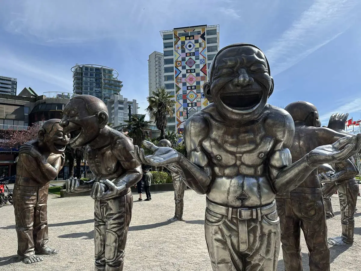 Laughing bronze statues at A-maze-ing Laughter art display in Vancouver.