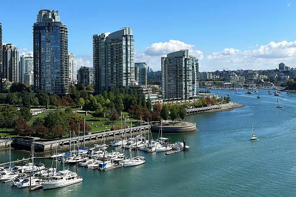 Boats docked at False Creek with downtown Vancouver high-rises in the background.