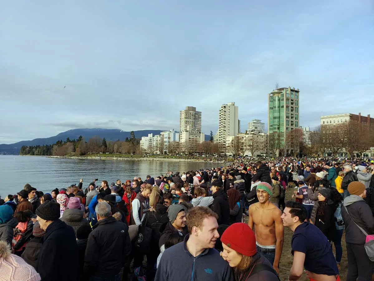 Crowd gathered at English Bay for the Polar Bear Swim in Vancouver.