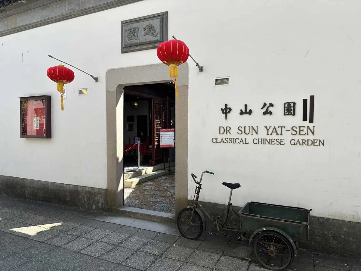 Entrance to the garden with Chinese lanterns and a vintage bike.