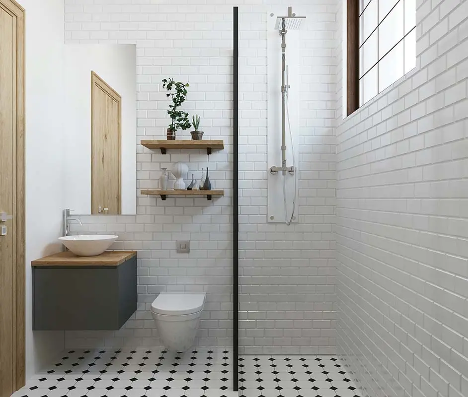 Clean bathroom with white subway tiles, floating vanity, open shelves, and a walk-in shower separated by a glass partition.