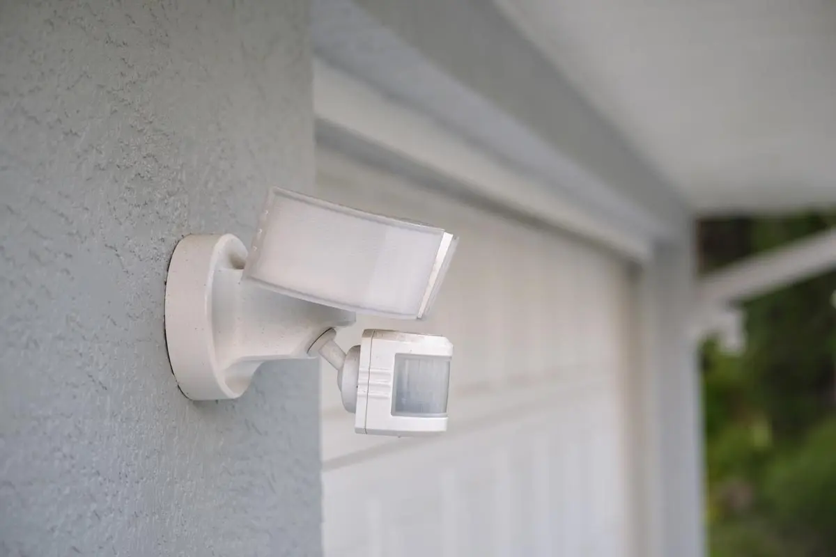 A motion-activated outdoor security light mounted on an exterior wall, enhancing safety and visibility around the home.