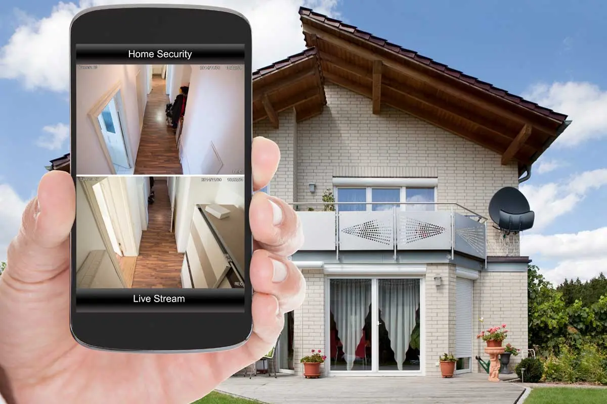 Viewing live home security camera feeds on a smartphone outside the house.