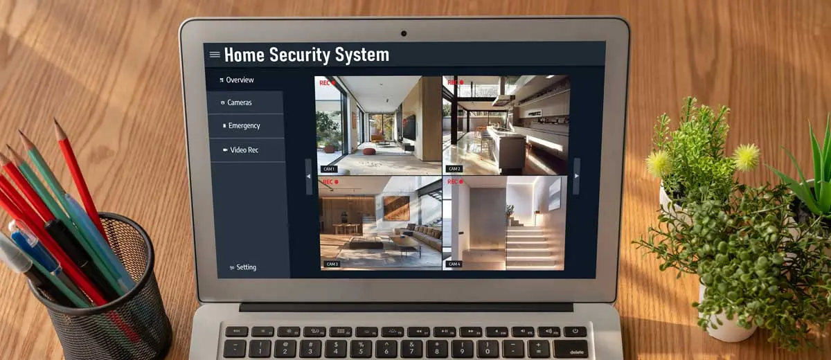 Laptop displaying a home security system interface with multiple live camera feeds.