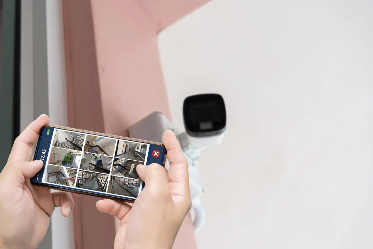 Viewing multiple security camera feeds on a smartphone for real-time monitoring and enhanced home security.